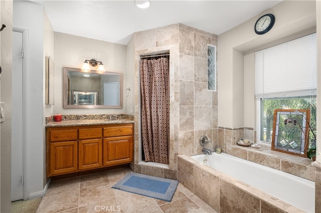 bathroom featuring vanity and independent shower and bath