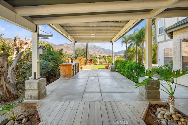 view of patio with a deck with mountain view