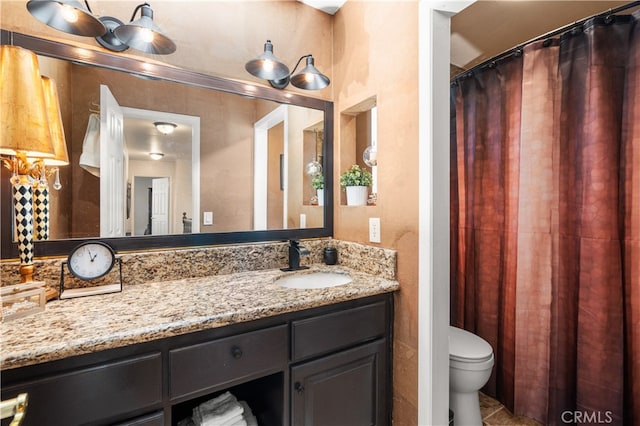 bathroom featuring vanity, toilet, and tile patterned floors