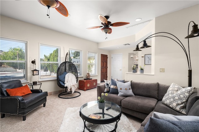 living room with a healthy amount of sunlight, light colored carpet, and ceiling fan