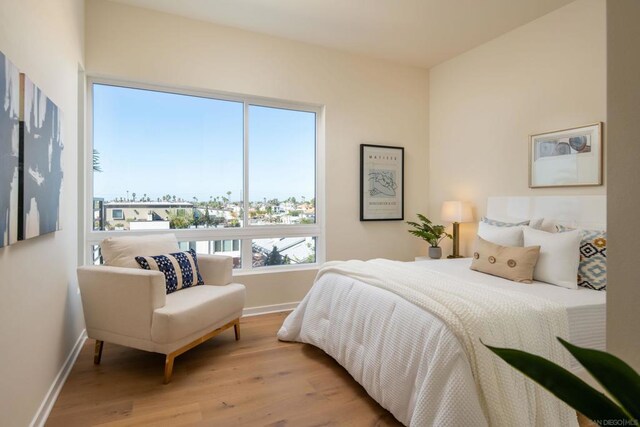 bedroom featuring multiple windows and light wood-type flooring