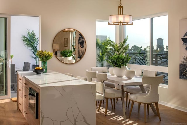 dining room featuring hardwood / wood-style flooring and an inviting chandelier