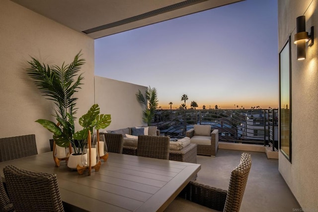 balcony at dusk with an outdoor hangout area