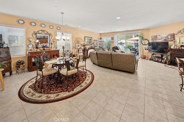 tiled living room featuring a notable chandelier