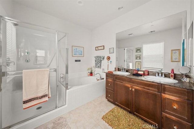 bathroom with tile patterned flooring, vanity, and independent shower and bath