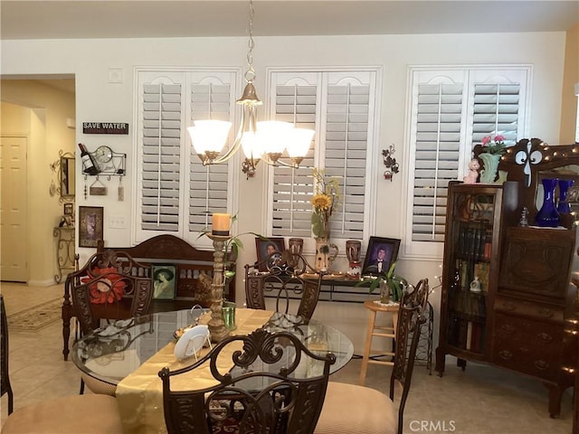 tiled dining area with a chandelier