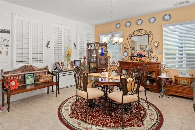 tiled dining space featuring a chandelier