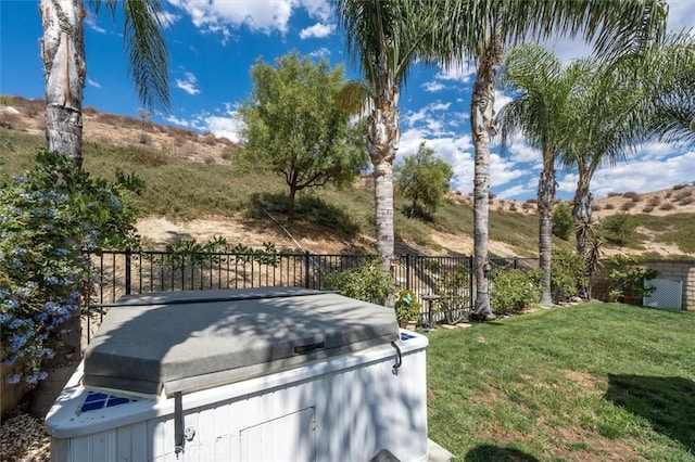 view of yard featuring a mountain view and a hot tub