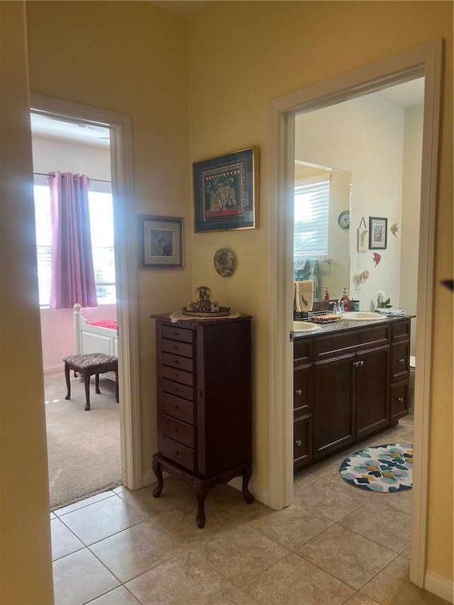 corridor with sink and light tile patterned floors