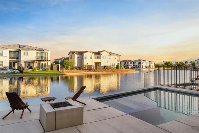 pool at dusk with a water view