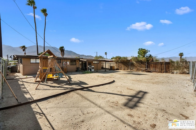 view of jungle gym featuring a mountain view