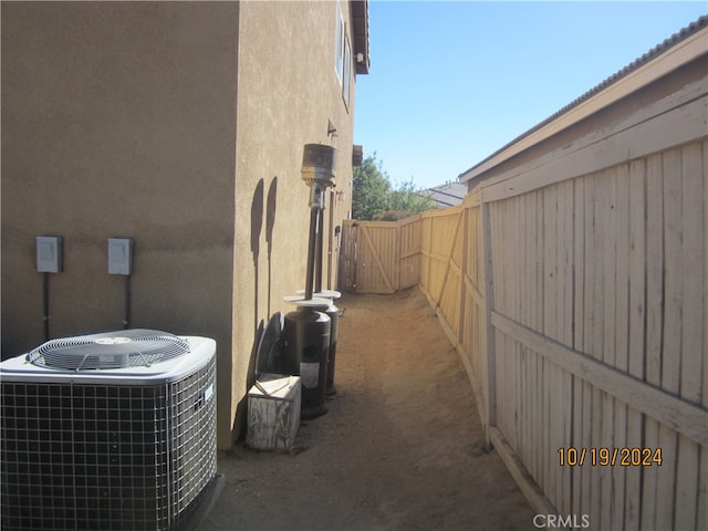 view of side of home with central air condition unit