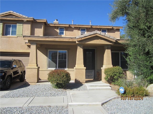 view of front of property featuring a garage and a porch