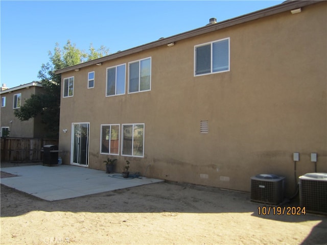 rear view of house featuring central air condition unit and a patio area