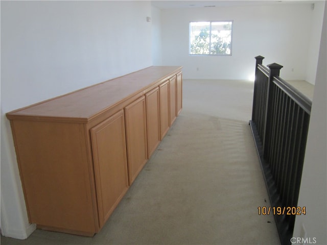 hallway featuring light carpet