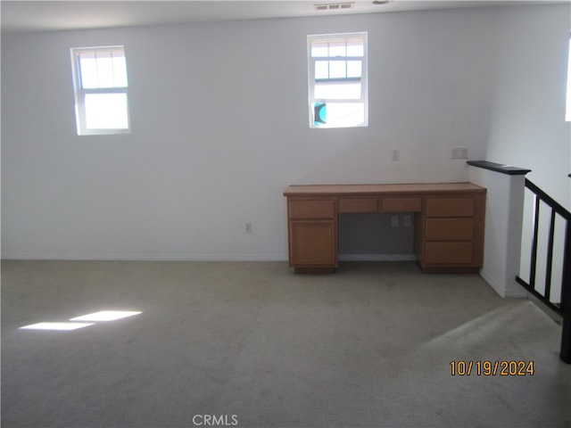 unfurnished office with light colored carpet and plenty of natural light