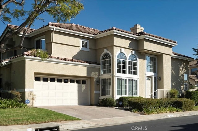 mediterranean / spanish-style home featuring a garage