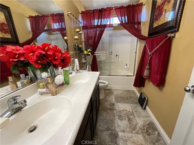 full bathroom featuring vanity, enclosed tub / shower combo, and toilet