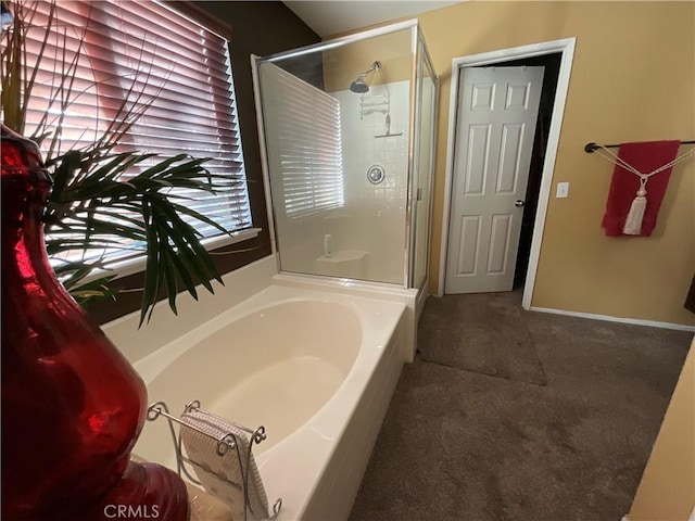 bathroom featuring separate shower and tub