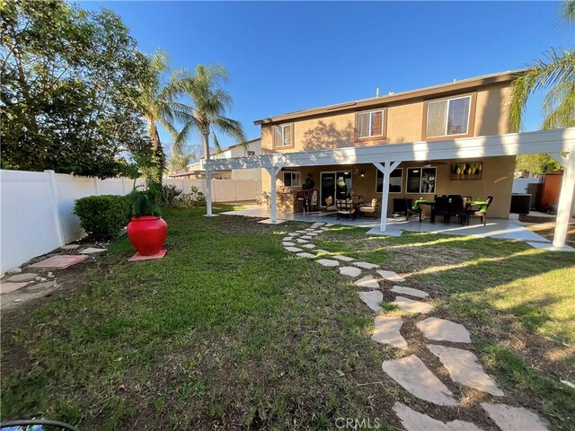 back of property featuring a pergola, an outdoor hangout area, a patio area, and a lawn