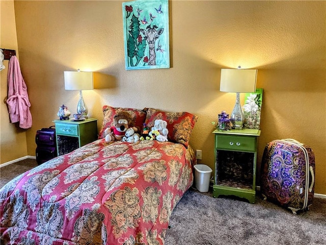 bedroom featuring carpet and a textured ceiling