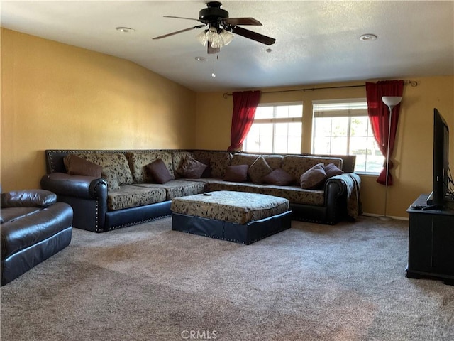 carpeted living room featuring vaulted ceiling and ceiling fan