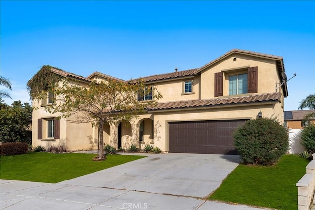 mediterranean / spanish house featuring a garage and a front lawn