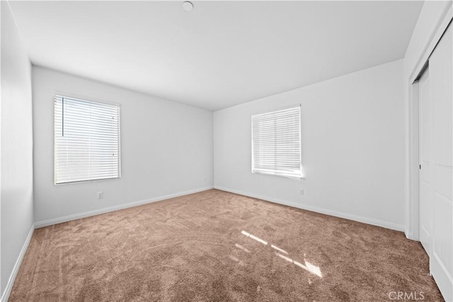 unfurnished bedroom featuring carpet and a closet