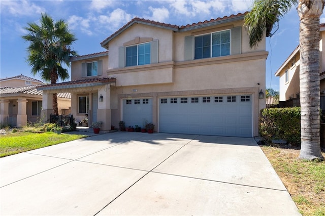 mediterranean / spanish home with a garage