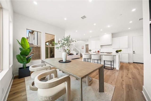 dining space with light wood-type flooring