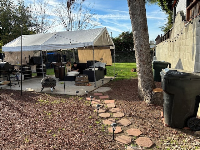 view of yard featuring an outdoor fire pit and a patio area