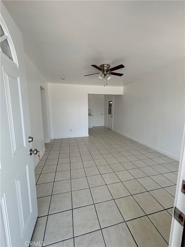 unfurnished room featuring ceiling fan and light tile patterned floors