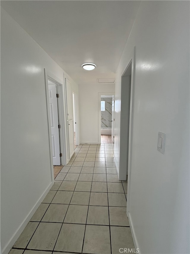 hall featuring light tile patterned floors