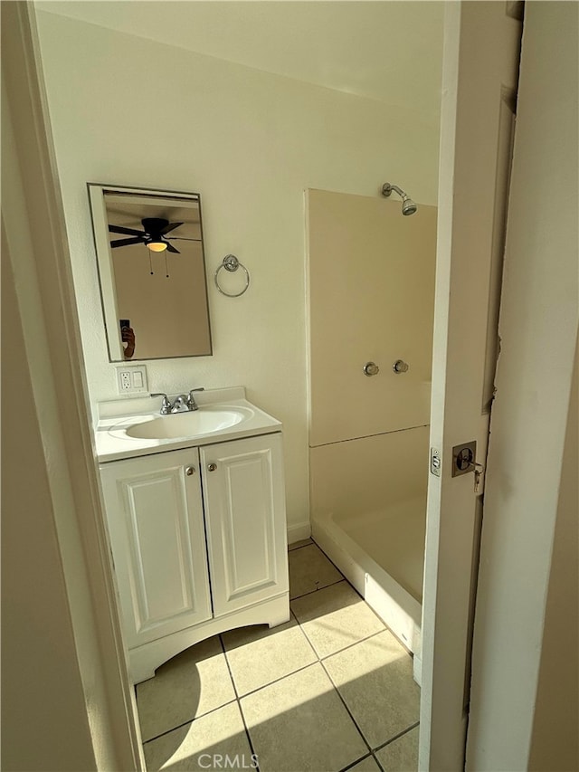 bathroom featuring vanity, ceiling fan, walk in shower, and tile patterned flooring