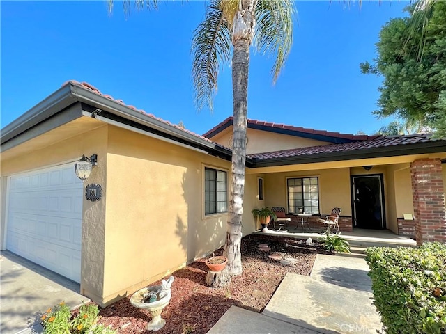 exterior space with covered porch and a garage