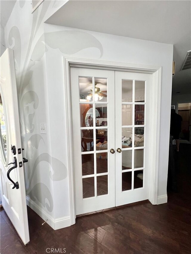 entryway featuring dark hardwood / wood-style flooring and french doors