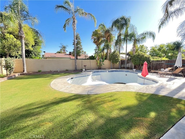 view of swimming pool featuring a yard and a patio