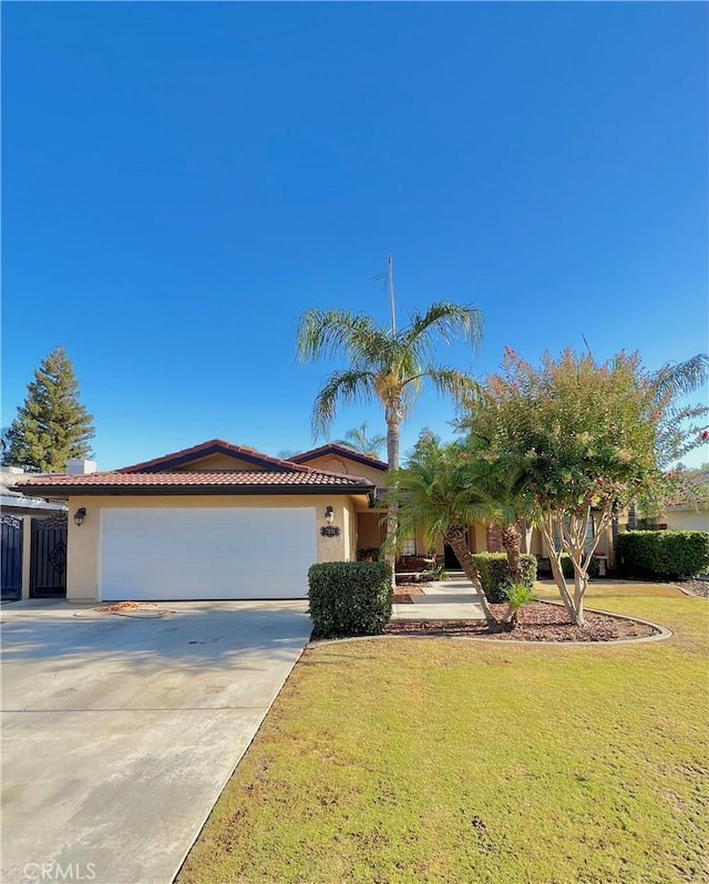 view of front of property with a garage and a front lawn