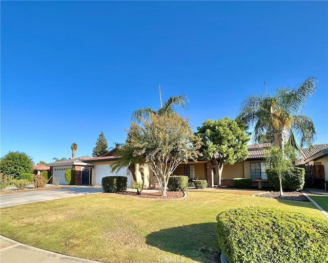 view of front of property with a front lawn and a garage