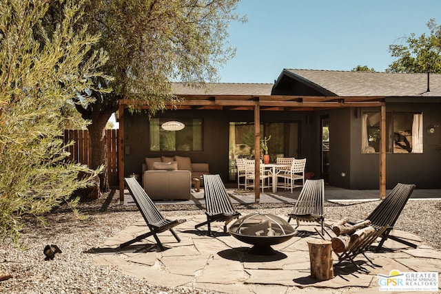 back of property featuring a patio area and an outdoor fire pit