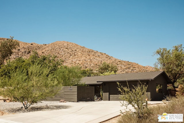 view of front of home featuring a garage and a mountain view