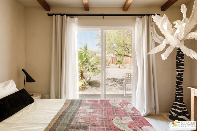 bedroom with multiple windows and beamed ceiling