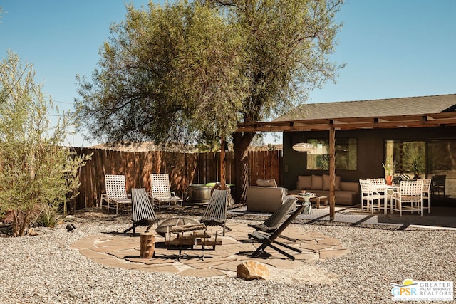 view of patio featuring an outdoor living space with a fire pit