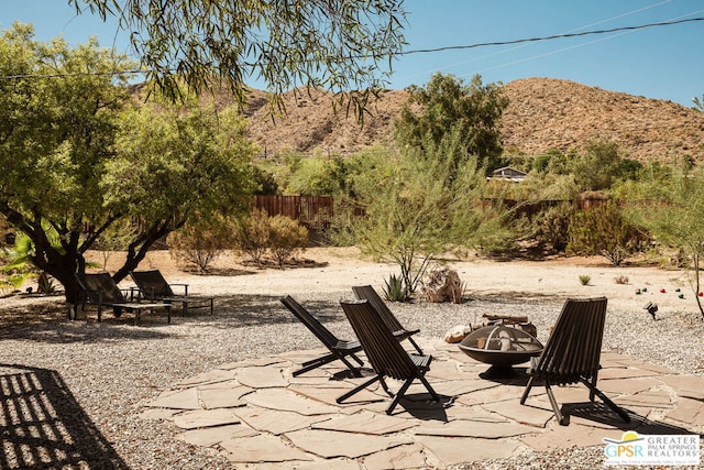 view of patio featuring a mountain view and a fire pit