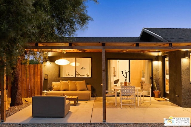 patio terrace at dusk featuring an outdoor living space