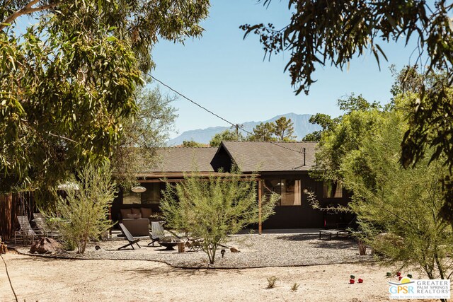 view of front of house featuring a patio area and a mountain view