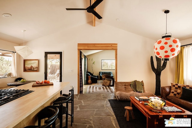 living room featuring ceiling fan and vaulted ceiling with beams