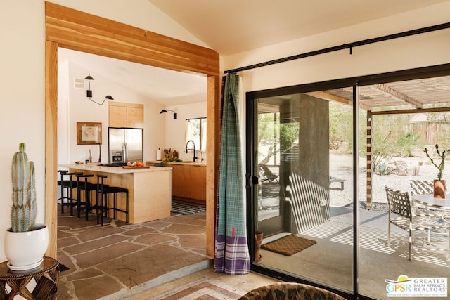 entryway featuring sink and vaulted ceiling