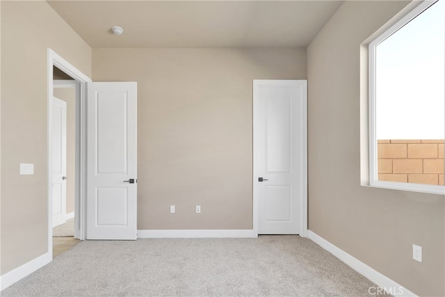 unfurnished bedroom with light colored carpet