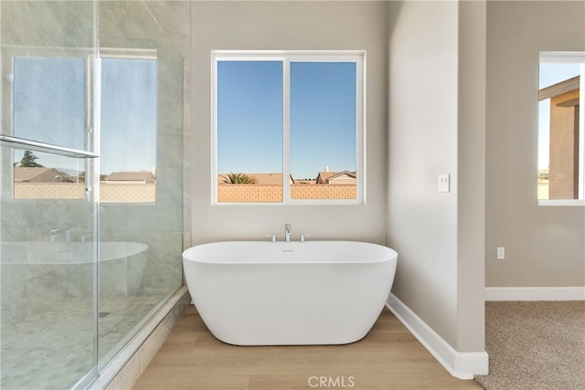 bathroom featuring hardwood / wood-style flooring and independent shower and bath